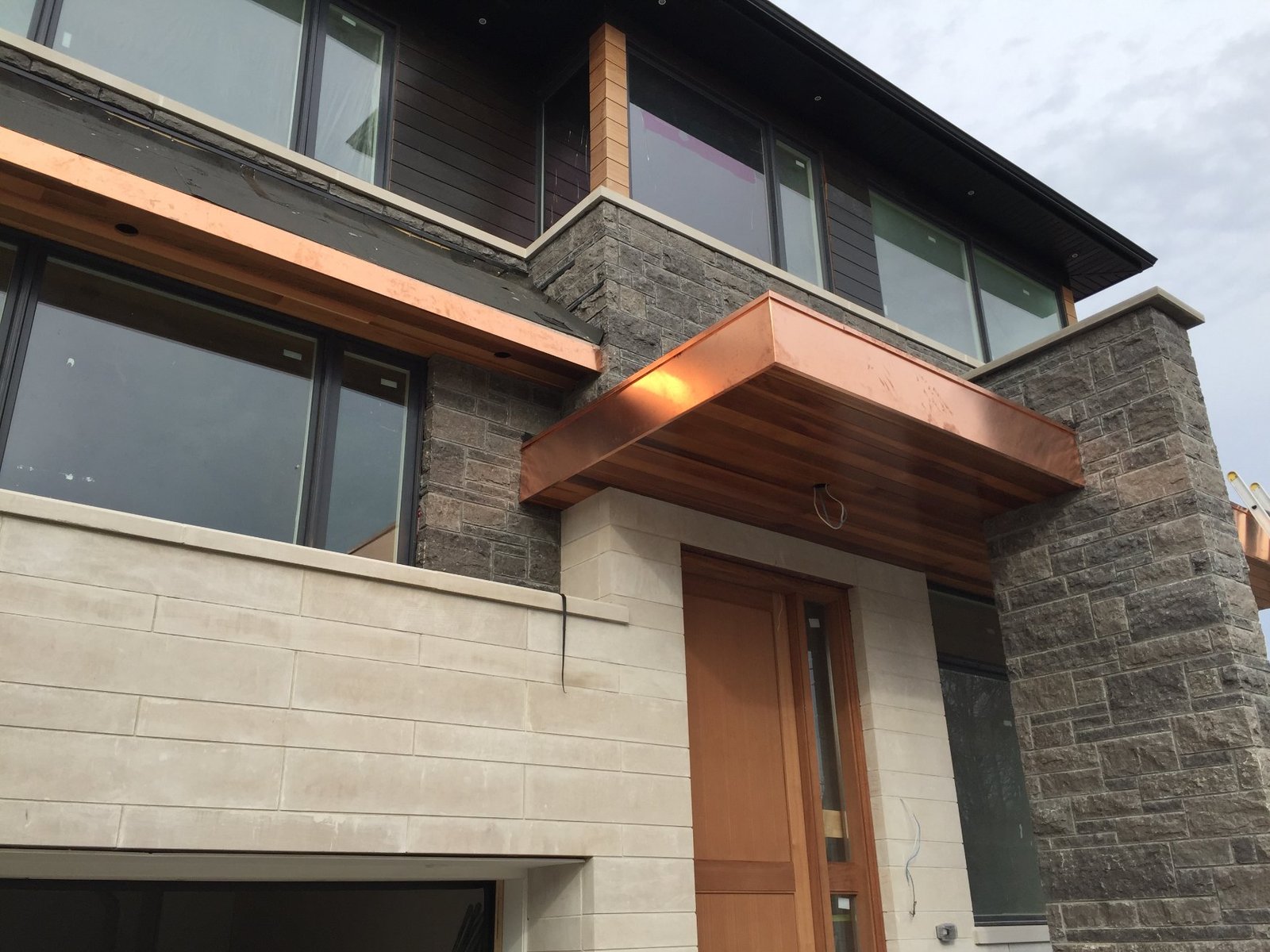 Custom copper entry canopy on a Toronto custom home