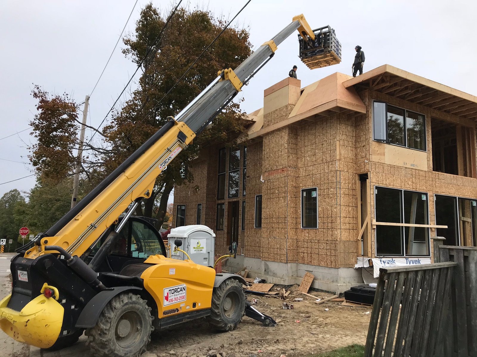 Custom new-build home with 416 Roofing crew on the roof